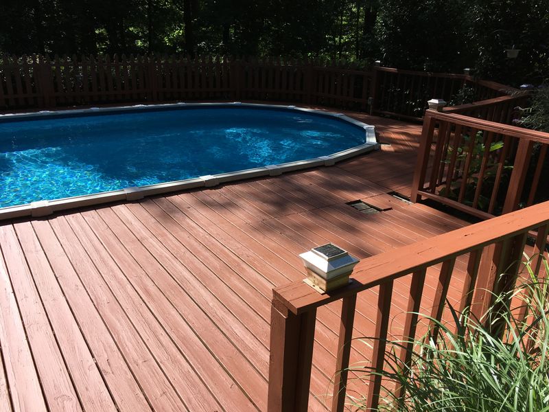 Above-ground pool deck and railings stained red-brown