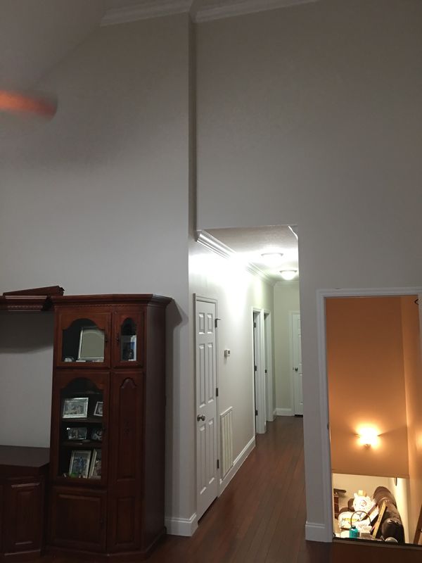 Hallway and living area with walls and trim painted white