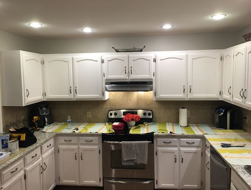 Kitchen with upper and lower cabinets painted white