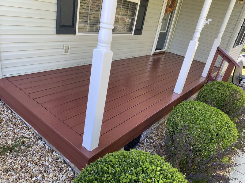Porch floor painted brick red with white posts
