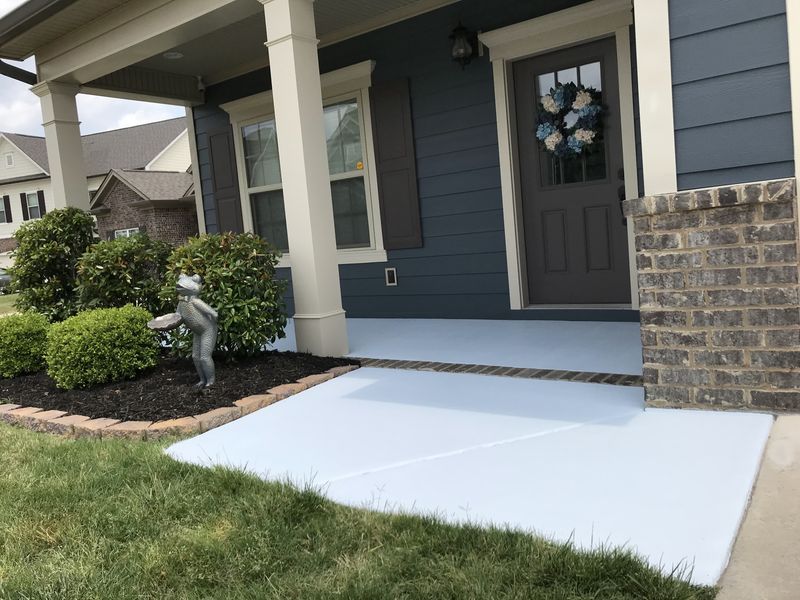 Front porch and walkway floor painted light gray, navy siding