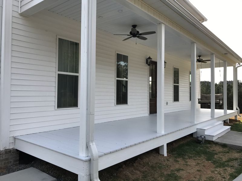 White farmhouse porch with painted floor, posts and ceiling