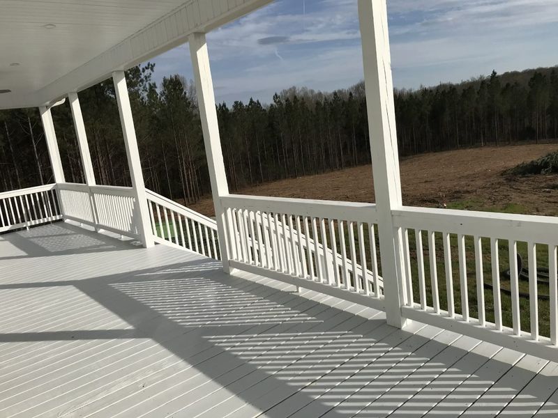 Wraparound porch with floor and railings painted white